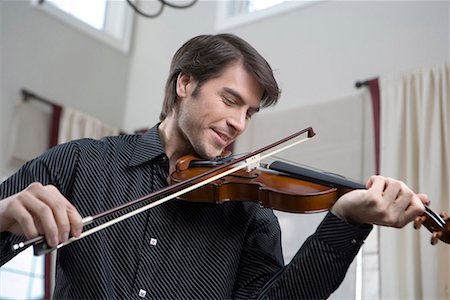 a western man playing the violin Stock Photo - Premium Royalty-Free, Code: 642-02006208