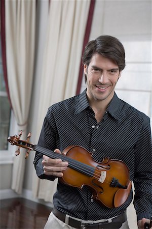 a western man playing the violin Stock Photo - Premium Royalty-Free, Code: 642-02006210