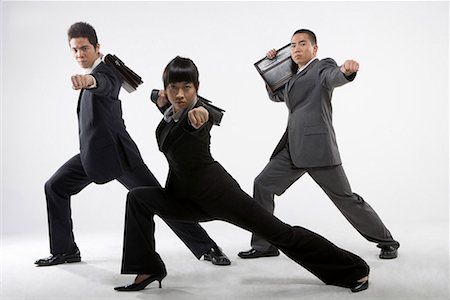 three business persons practicing Chinese Kungfu Stock Photo - Premium Royalty-Free, Code: 642-02006565