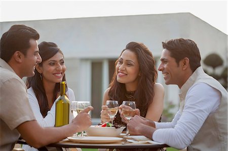 friends outside 30s - India, Friends drinking wine at table on backyard Stock Photo - Premium Royalty-Free, Code: 655-08357127