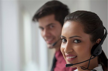 simsearch:6109-06002816,k - India, Two telemarketers smiling to camera Stock Photo - Premium Royalty-Free, Code: 655-08357173
