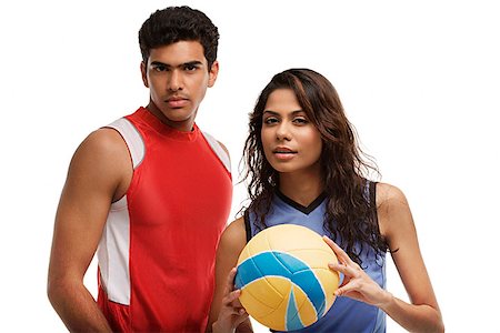 Young couple with beach ball looking at camera Stock Photo - Premium Royalty-Free, Code: 655-01781497