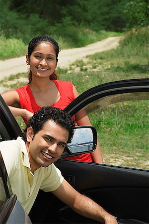 simsearch:625-00801301,k - Young couple with car smiling at camera Stock Photo - Premium Royalty-Free, Code: 655-01781509