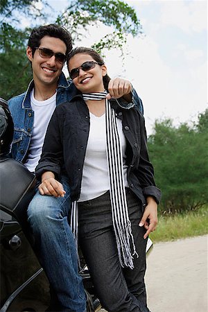 simsearch:614-06896253,k - Young couple with motorbike smiling at camera Stock Photo - Premium Royalty-Free, Code: 655-01781526