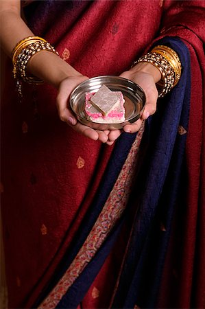 singapore traditional costume lady - Indian woman offering sweets Stock Photo - Premium Royalty-Free, Code: 655-02375849