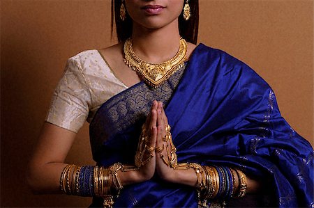 singapore traditional clothing - Indian woman with hands held in prayer position Stock Photo - Premium Royalty-Free, Code: 655-02375858