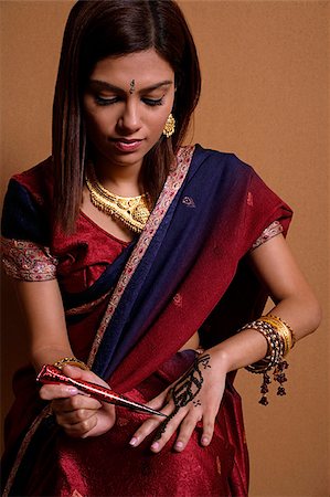 Indian woman painting hand with henna Stock Photo - Premium Royalty-Free, Code: 655-02375864