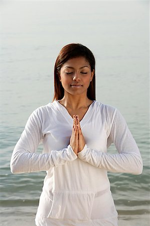 woman practicing yoga on the beach, eyes closed Stock Photo - Premium Royalty-Free, Code: 655-02702899