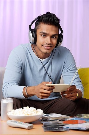 young man listening to music with headphones on Stock Photo - Premium Royalty-Free, Code: 655-02703007