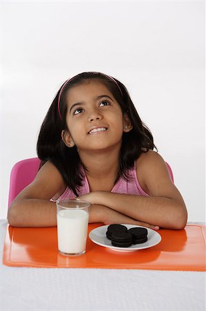 dreaming about eating - Girl with milk and cookies Stock Photo - Premium Royalty-Free, Code: 655-02883025
