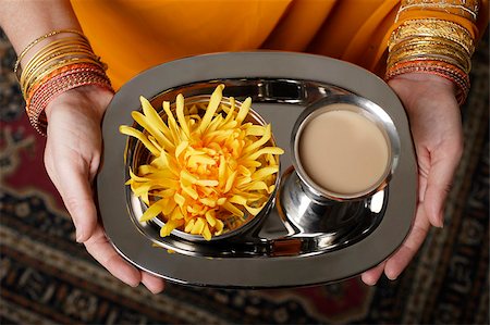 singapore traditional costume lady - tight shot of woman holding a tray with tea. Stock Photo - Premium Royalty-Free, Code: 655-03082783