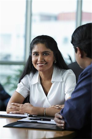 simsearch:655-03458001,k - Indian woman smiling during meeting Stock Photo - Premium Royalty-Free, Code: 655-03458005