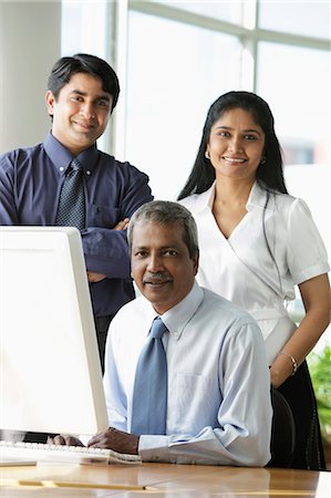 simsearch:655-03458001,k - Indian business people smiling in front of computer. Stock Photo - Premium Royalty-Free, Code: 655-03458027