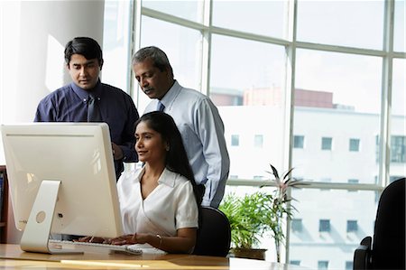 simsearch:655-03458001,k - Indian business people looking at a computer Stock Photo - Premium Royalty-Free, Code: 655-03458021