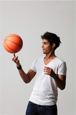 young man twirling basket ball on his finger Stock Photo - Premium Royalty-Free, Code: 655-03519587