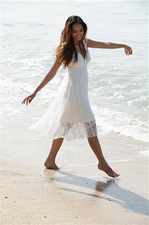 young woman dancing on the sand at the beach Stock Photo - Premium Royalty-Free, Code: 655-03519715