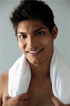 head shot of young man with towel around his neck and smiling Stock Photo - Premium Royalty-Free, Code: 655-03519720