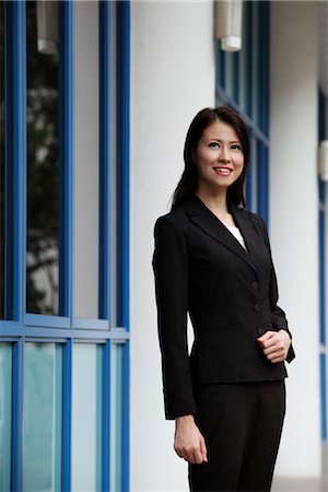 Woman wearing a suit looking up Stock Photo - Premium Royalty-Free, Code: 656-04926483