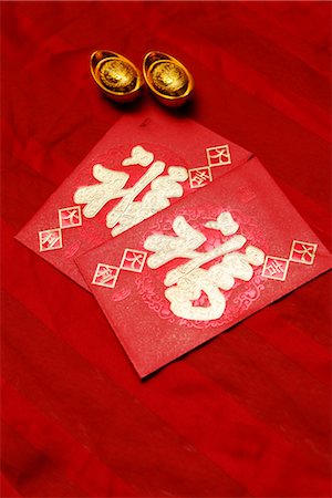 Red envelopes, Hong Bao, and Chinese gold ingots Stock Photo - Premium Royalty-Free, Code: 656-04926617