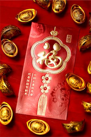 Gold ingots and red envelope (Hong Bao) Stock Photo - Premium Royalty-Free, Code: 656-04926623