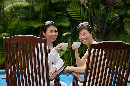 families wealthy - Two women sitting side by side outdoors, holding cups, turning to look at camera Stock Photo - Premium Royalty-Free, Code: 656-01765555