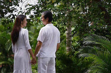 simsearch:6128-08738334,k - Couple in garden, holding hands, looking at each other Stock Photo - Premium Royalty-Free, Code: 656-01765806