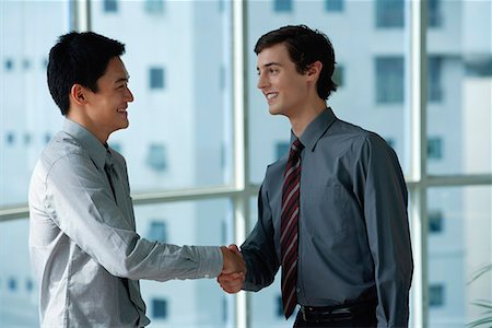 Two male colleagues shake hands Stock Photo - Premium Royalty-Free, Code: 656-01766224