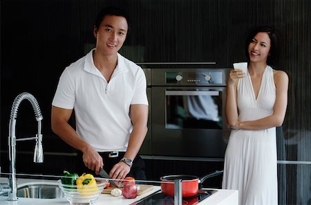 friends cooking inside - A couple prepare dinner together in the kitchen Stock Photo - Premium Royalty-Free, Code: 656-01766535