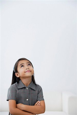 simsearch:700-01716701,k - A young girl dressed in school uniform crosses her arms Stock Photo - Premium Royalty-Free, Code: 656-01766537
