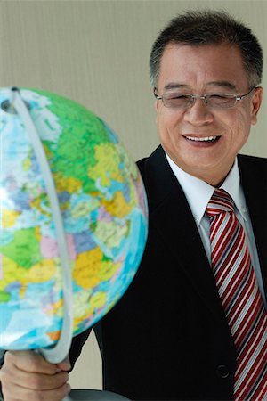 A man in suit holds a globe Stock Photo - Premium Royalty-Free, Code: 656-01766560