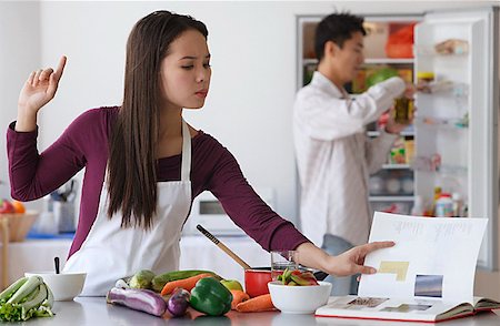 friends cooking inside - Young couple cooking in the kitchen Stock Photo - Premium Royalty-Free, Code: 656-01766738