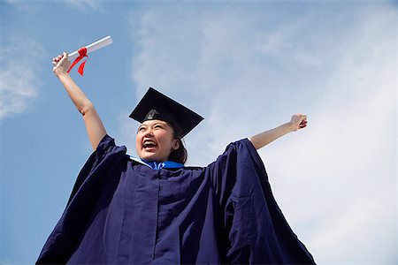 University student in graduation robe cheering Stock Photo - Premium Royalty-Free, Code: 656-01766836