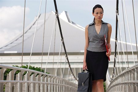 Businesswoman walking while looking into distance Stock Photo - Premium Royalty-Free, Code: 656-01766885