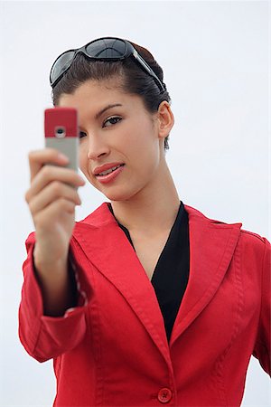 Woman taking picture with mobile phone Stock Photo - Premium Royalty-Free, Code: 656-01766934