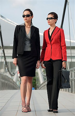 Two businesswomen looking into distance Stock Photo - Premium Royalty-Free, Code: 656-01766979