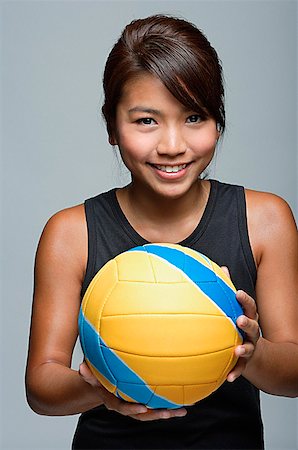 simsearch:858-03050428,k - Young woman with volleyball smiling at camera Stock Photo - Premium Royalty-Free, Code: 656-01767015