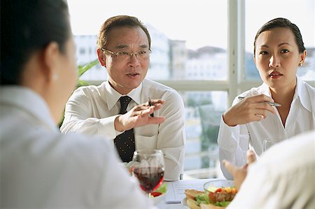 simsearch:655-03458001,k - Executives having lunch meeting, over the shoulder view Stock Photo - Premium Royalty-Free, Code: 656-01767691