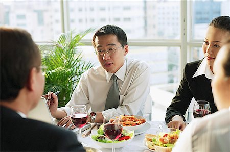 Businessmen and women, talking over lunch Stock Photo - Premium Royalty-Free, Code: 656-01767706