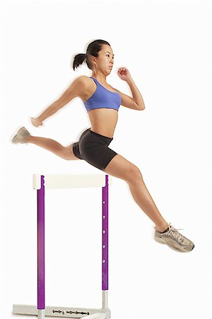 singapore jump - Woman jumping over hurdle Stock Photo - Premium Royalty-Free, Code: 656-01767948