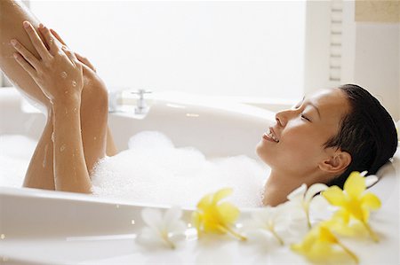 Woman taking a bath, washing leg Stock Photo - Premium Royalty-Free, Code: 656-01770165