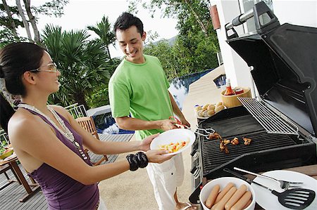 simsearch:6109-06781569,k - Couple grilling food on barbeque Stock Photo - Premium Royalty-Free, Code: 656-01770176