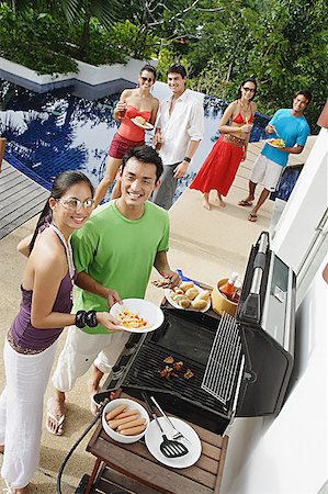simsearch:6109-06781569,k - Friends at barbeque party, smiling at camera Stock Photo - Premium Royalty-Free, Code: 656-01770178