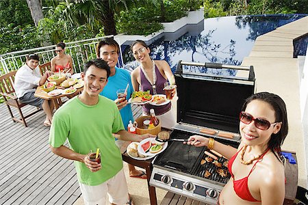 simsearch:6109-06781569,k - Friends at barbeque party, smiling at camera Stock Photo - Premium Royalty-Free, Code: 656-01770185