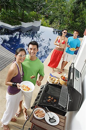 pool party - Couples at barbeque party, smiling at camera Stock Photo - Premium Royalty-Free, Code: 656-01770181