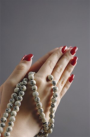 recognition - Womans hands in praying position with prayer beads Stock Photo - Premium Royalty-Free, Code: 656-01771178