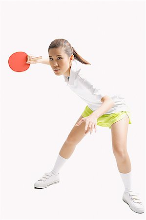 Young woman playing table tennis, studio shot Stock Photo - Premium Royalty-Free, Code: 656-01771290