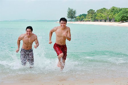 friends competing - Two men running along the beach Stock Photo - Premium Royalty-Free, Code: 656-01772854