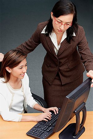 role model (female) - Businesswomen looking at computer Stock Photo - Premium Royalty-Free, Code: 656-01772912
