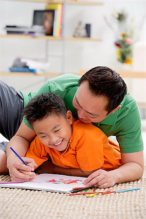Father and son at home, drawing on sketch pad Stock Photo - Premium Royalty-Free, Code: 656-01773026