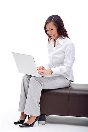 Business woman sitting on bench, using laptop Stock Photo - Premium Royalty-Free, Code: 656-01773169